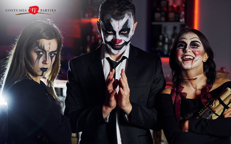 People wearing clown and gothic-inspired Halloween costumes.